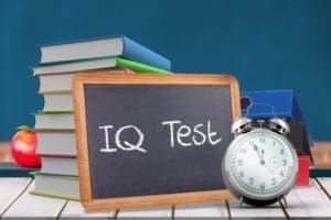 school books and clock showing time showing child IQ test on the board